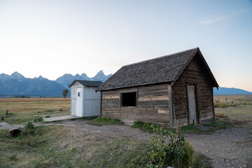 Rustic Wooden Cabin with Mountain Background in Countryside