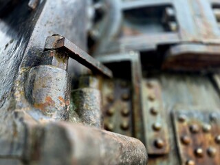 Large size bolts and nuts in iron and steel factories, old vintage rusty metal door