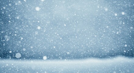 A serene winter scene captures the beauty of a snowfall with delicate snowflakes against a soft, blurred background. The tranquility of the season is palpable in this elegant photographic depiction.
