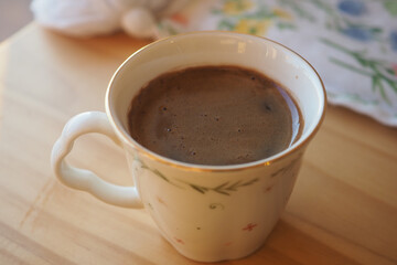 Warm cup of hot chocolate on a wooden table