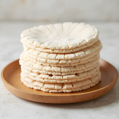 Stack of Beige Reusable Pads on Wooden Plate