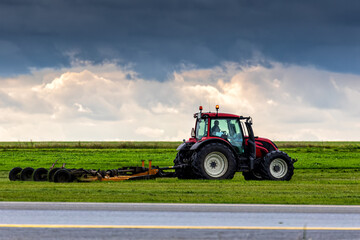 Fototapeta premium Wheel tractor with lawn mower by the road