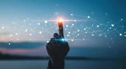 Finger touches a glowing, networked connection against a twilight sky