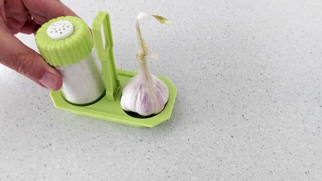 Compact kitchen tool with dual compartments: store garlic on one side, dispense seasoning from the other. A clever, space-saving gadget for streamlined cooking prep