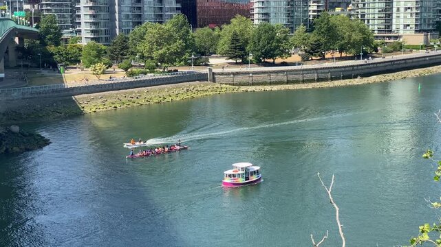 Vancouver tourist Aquabus and dragonboat team watercraft in false creek water during day 