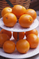 Oranges neatly arranged on a tiered display stand