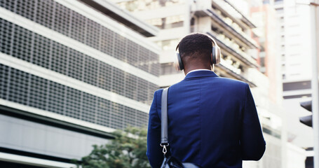 Travel, employee and man with headphones, city and commuting to work, streaming and listen to...
