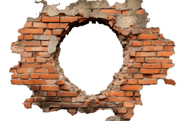 Damaged brick wall with a circular hole revealing emptiness behind it in an urban setting