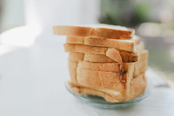 The texture of the bread is soft and fluffy, contrasted with the dark insect, emphasizing the importance of cleanliness, food safety, and proper storage.