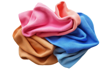 Colorful collection of crumpled microfiber cloths twisted together on a light background showcasing vibrant hues and various textures for cleaning or decoration