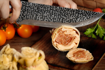 Fresh Pork Belly Preparation with Chef's Knife and Vegetables on Wooden Cutting Board