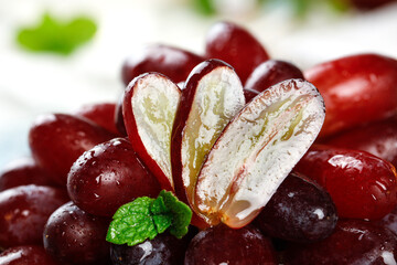 Fresh Red Grapes Cut in Half with Mint Leaves - Healthy Fruit Food Photography