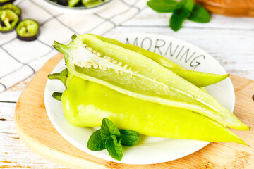Fresh Yellow Chili Peppers Sliced on White Plate with Mint Leaves Kitchen Food Photography