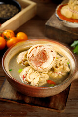 Mongolian Lamb Belly Roll Soup in Traditional Clay Bowl - Authentic Asian Cuisine with Fresh Herbs and Vegetables