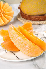 Fresh Sweet Cantaloupe Melon Slices on Marble Surface with Whole Fruit in Wicker Basket