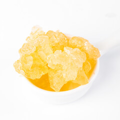 Handmade Yellow Rock Candy Crystals Made with Traditional Ancient Large Grain Method on White Background