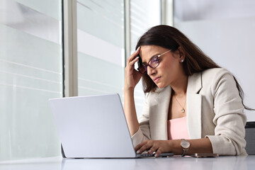 Professional Woman Focused on Work in a Bright Office