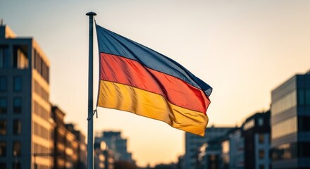 Waving German flag against buildings, warm light