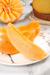 Fresh Sliced Cantaloupe Melon Wedges on White Marble Plate - Healthy Organic Fruit Snack