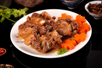 Braised Oxtail Stew with Carrots and Herbs - Traditional Comfort Food Dish