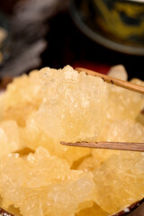 Yunnan Yellow Rock Candy Crystals Held with Chopsticks - Traditional Chinese Sweet Confection