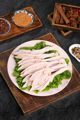 Fresh Raw Duck Wings Display with Spices and Herbs for Cooking Preparation