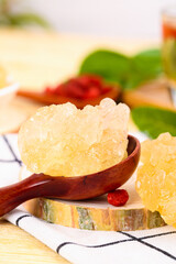 Yellow Rock Sugar Crystals in Antique Wooden Spoon - Natural Sweetener Ingredients