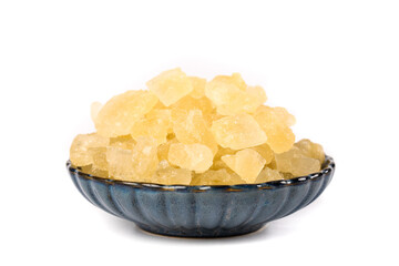Yellow Raw Sugar Crystals in Blue Glass Bowl on White Background