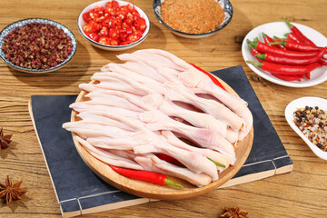 Raw Duck Feet Sliced with Spices and Cooking Ingredients on Wooden Cutting Board for Asian Cuisine Preparation