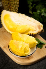 Fresh Golden Durian Fruit from Thailand with Creamy Pulp on Wooden Board