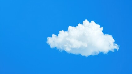 A single fluffy white cumulus cloud floating in a vast clear blue sky