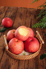 Fresh Red Fuji Apples from Luochuan China in Wicker Basket on Rustic Wood Table Bottom View Deep Texture Natural Organic Fruit Display