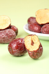 Xinjiang Red Dates - Fresh Dried Chinese Jujube Fruits on Green Background