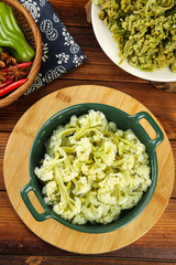 Sichuan Style Cauliflower with Dried Vegetables in Rustic Kitchen Setting