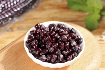 Purple Glutinous Corn from Xishuangbanna Yunnan China in White Bowl on Wooden Board