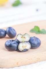Fresh Blueberries Cut in Half on Wooden Board Showing Interior Detail