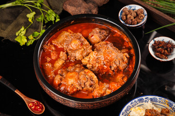 Braised Oxtail Stew in Spiced Tomato Base with Fresh Herbs and Traditional Asian Seasonings