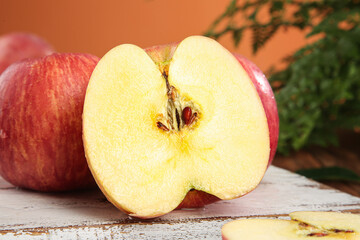 Fresh Red Apple Cut in Half Showing Interior on Rustic Wood Surface