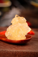 Yellow Rock Sugar Cubes on Wooden Spoon - Traditional Handmade Crystalline Sweetener