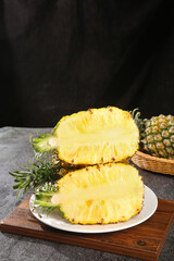 Fresh Cut Pineapple Halves Showing Sweet Yellow Pulp on Wooden Board