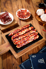 Variety of Dried Cured Meats Sausages and Jerky on Rustic Wooden Boards