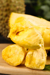 Fresh Cut Golden Durian Fruit Segments on Wooden Board - Thai Tropical Exotic Food Closeup