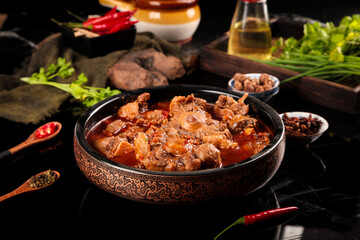 Spicy Stewed Oxtail with Bones in Traditional Bowl - Asian Beef Tail Dish with Fresh Herbs and Chili Peppers