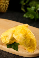 Fresh Golden Durian Fruit Flesh Segments on Wooden Board - Exotic Tropical Asian Delicacy