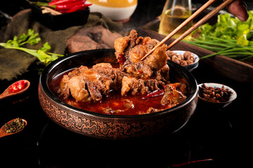 Spicy Oxtail Stew in Traditional Bowl with Chopsticks and Fresh Herbs