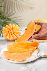 Fresh Sweet Cantaloupe Melon Slices Closeup - Hand Holding Ripe Xinjiang Fruit with Crispy Reticulated Skin