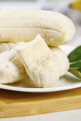Fresh Cut Banana Pieces with Yellow Flesh on White Plate Display
