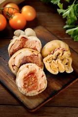 Raw Lamb and Tripe Wrapped with String on Wooden Board with Fresh Vegetables