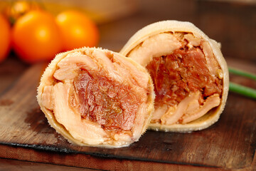 Sweet filled pastry buns with jam preserves cut in half showing delicious filling on wooden board