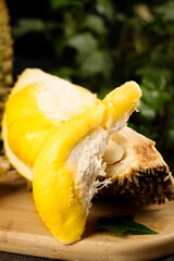 Fresh Durian Fruit with Golden Flesh and Spiky Shell Display on Wooden Board